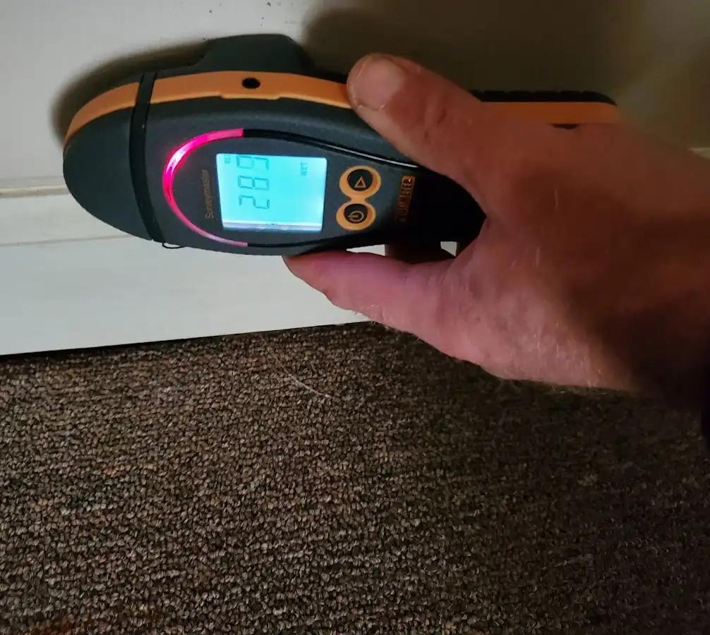 Moisture detection at baseboard during Storm Damage Restoration in Hillsborough